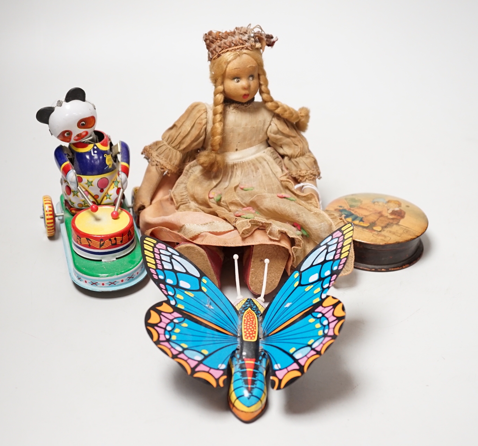 Two tin plate clockwork toys, a doll and a treen box